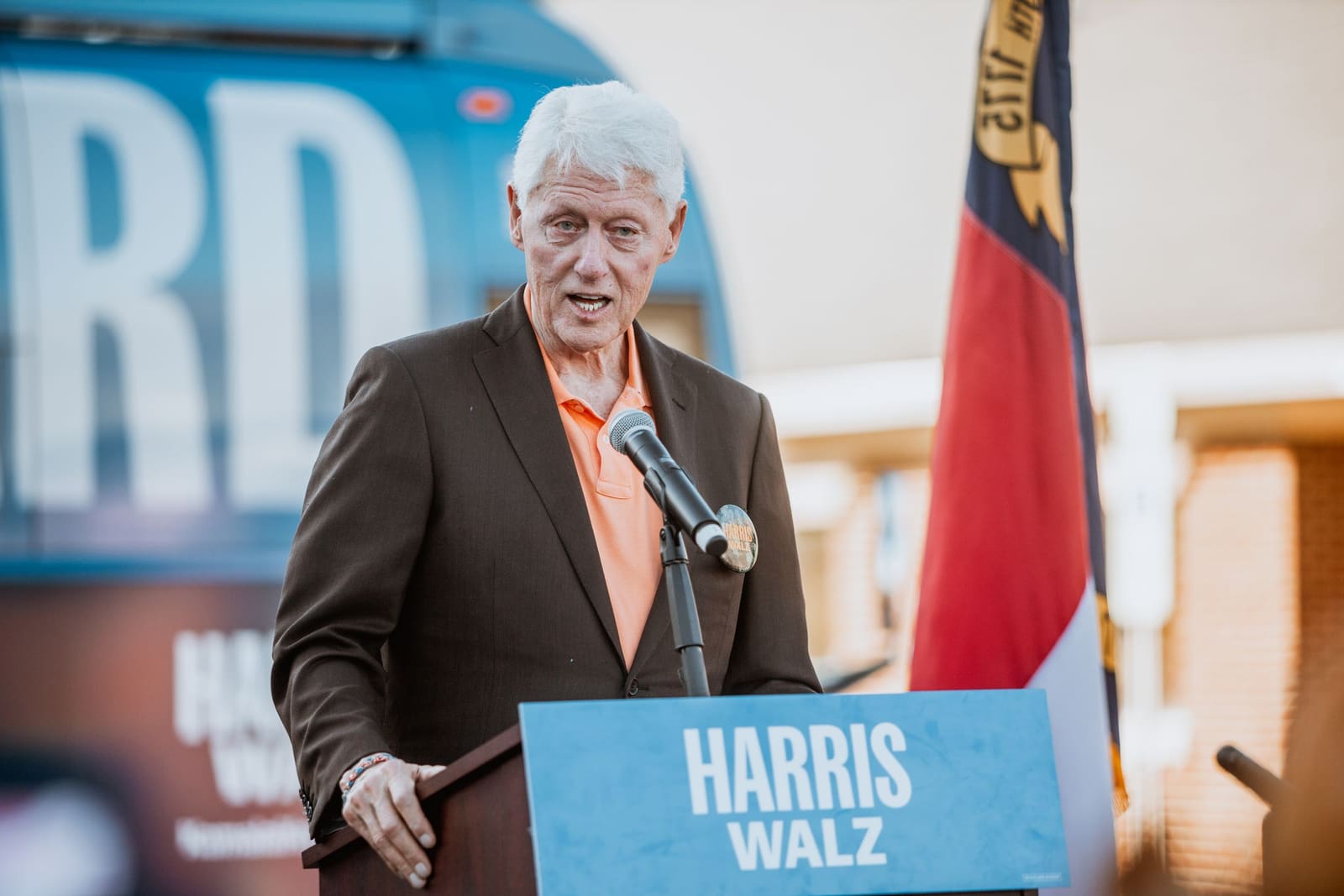 Bill Clinton speaks at a Harris campaign podium in Greenville, NC, October 2024