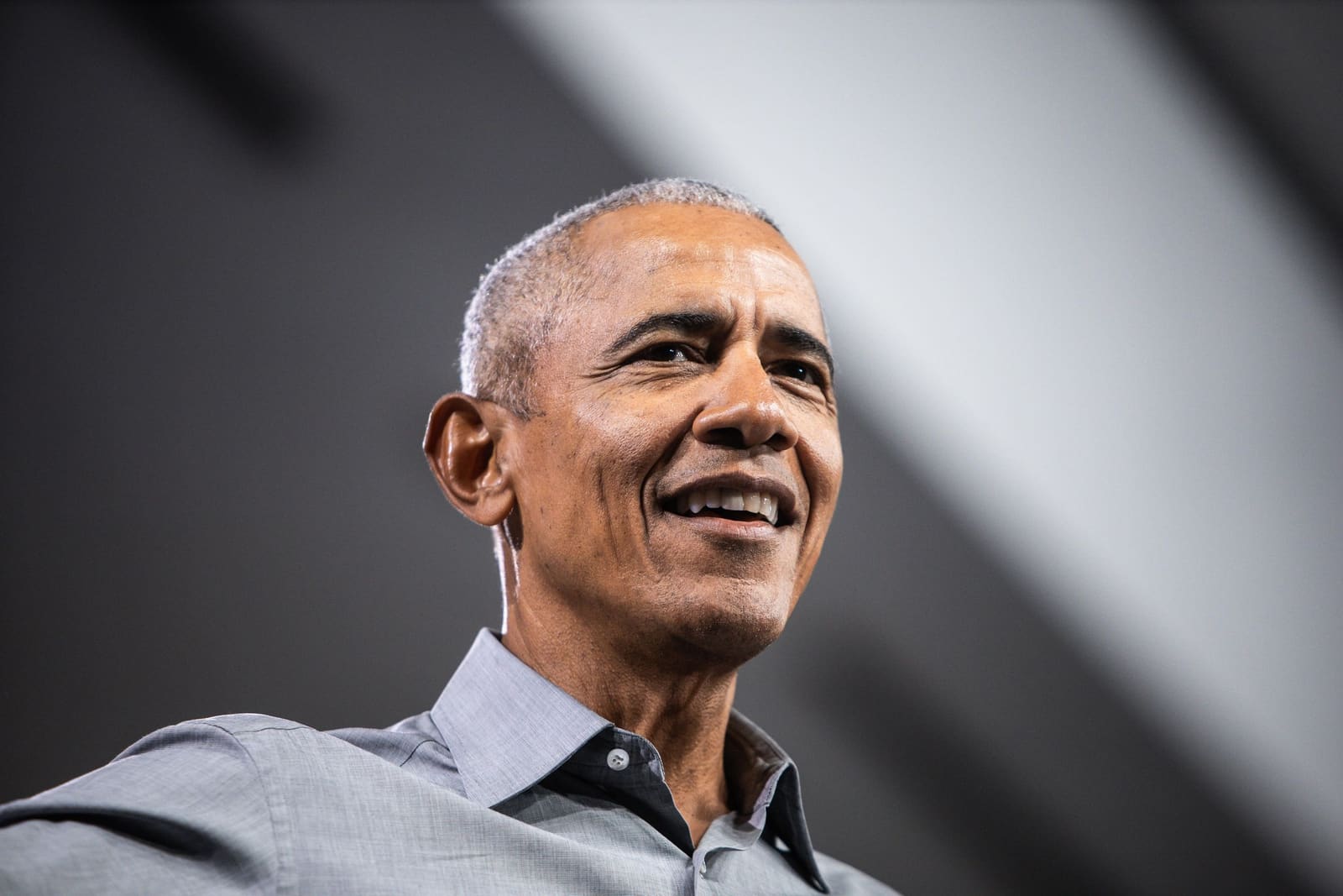 Barack Obama smiles on stage at a rally in Charlotte, NC, October 2024