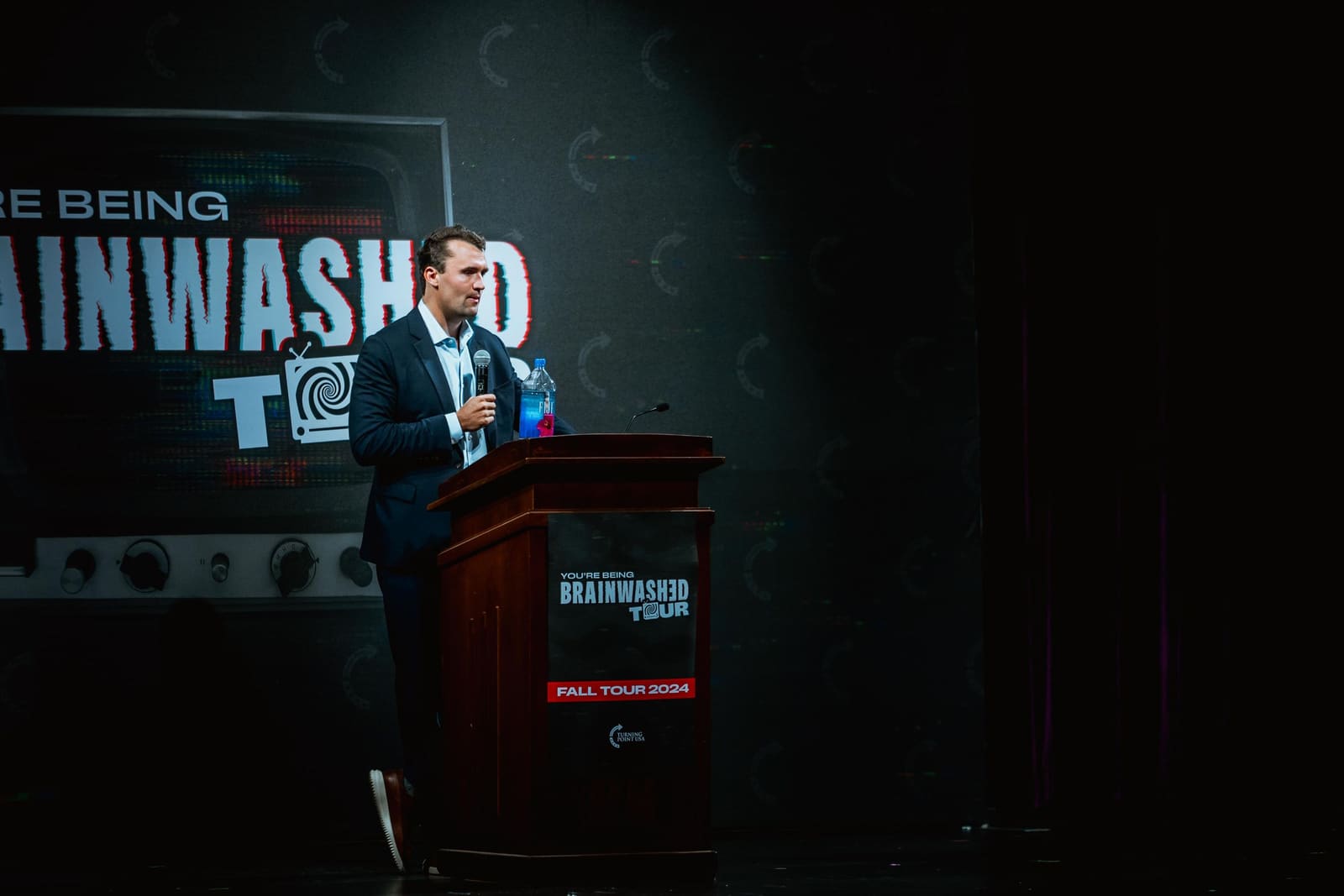 Charlie Kirk at the podium on the Brainwashed Tour, fall 2024