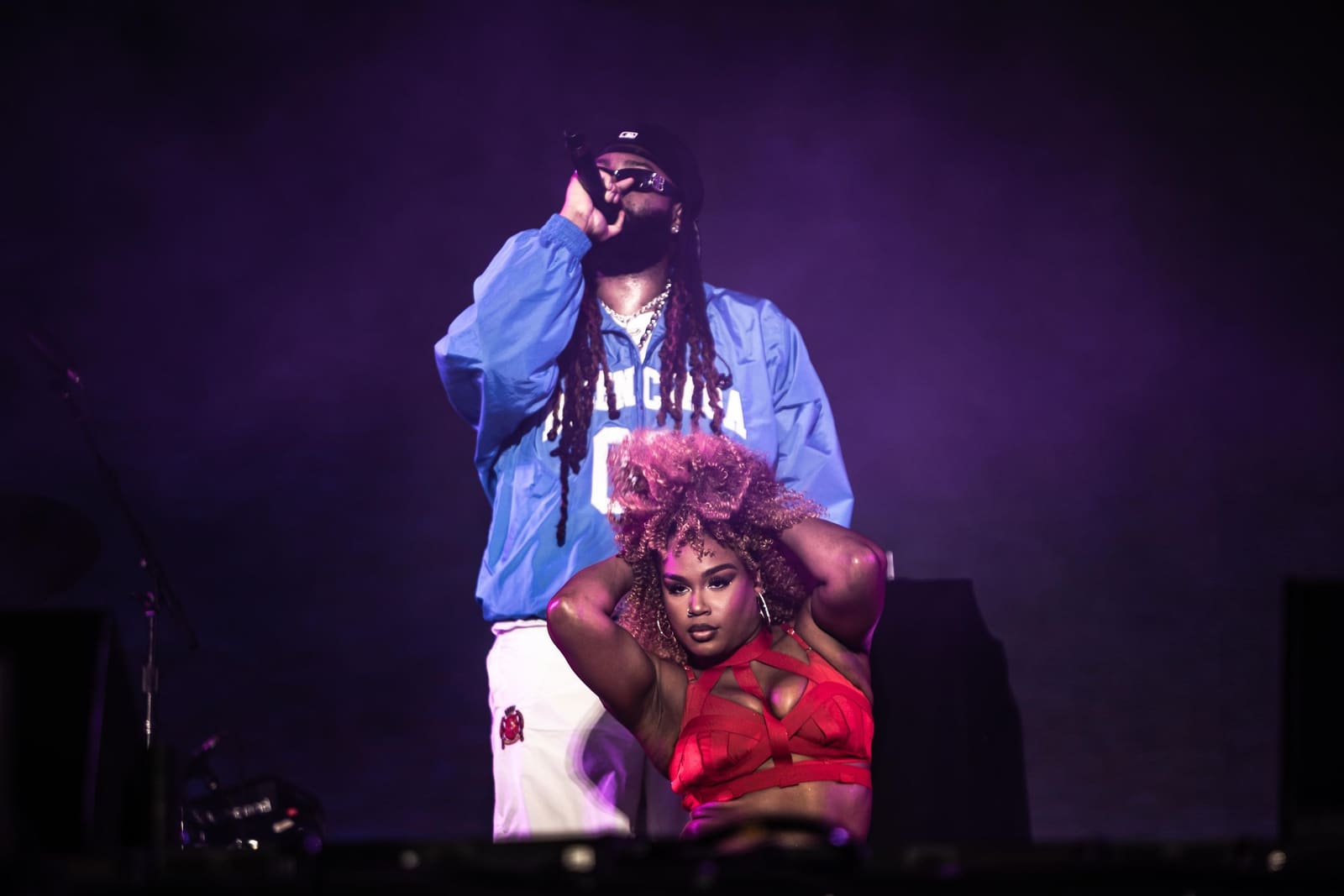 A rapper performs with a dancer seated below him at Dreamville Festival, Raleigh, 2025