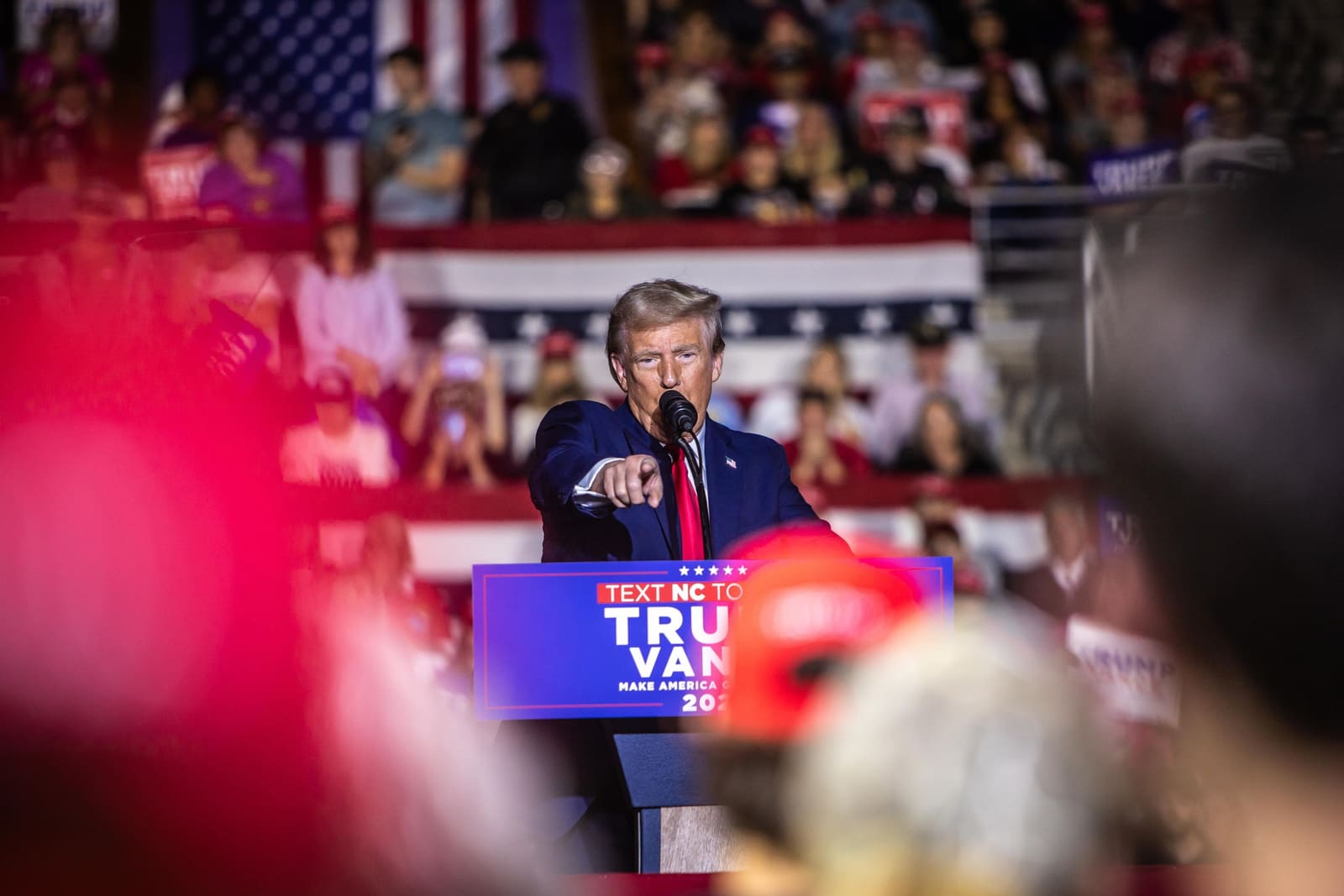 Donald Trump points to the crowd at an energetic Trump Vance 2024 campaign rally in North Carolina.