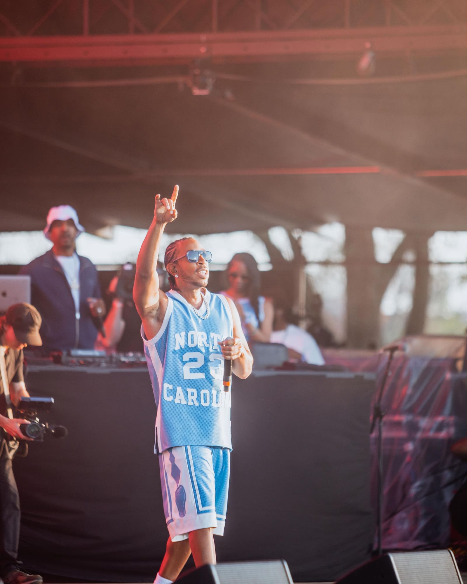 Ludacris points upward during his set at Dreamville Festival, Raleigh