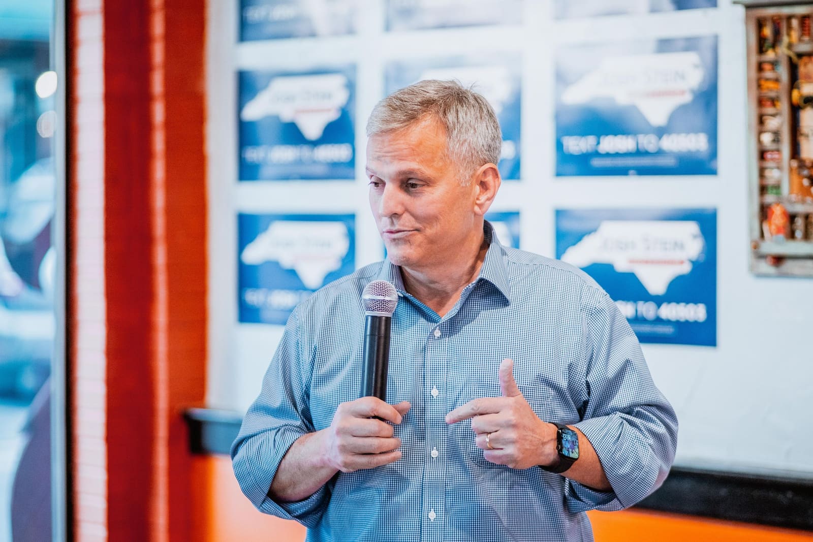 Josh Stein gives a thumbs up while speaking in Greenville, NC