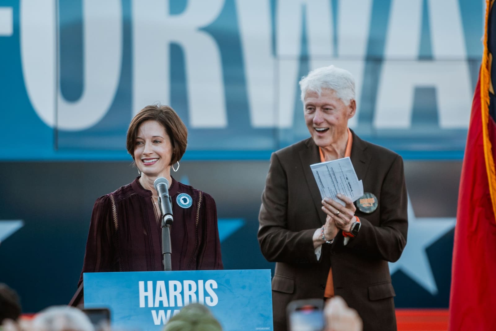 Bill Clinton on stage with another speaker at a Greenville, NC rally