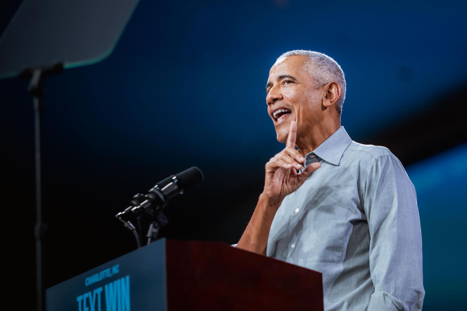 Barack Obama smiles and gestures at the podium in Charlotte, NC