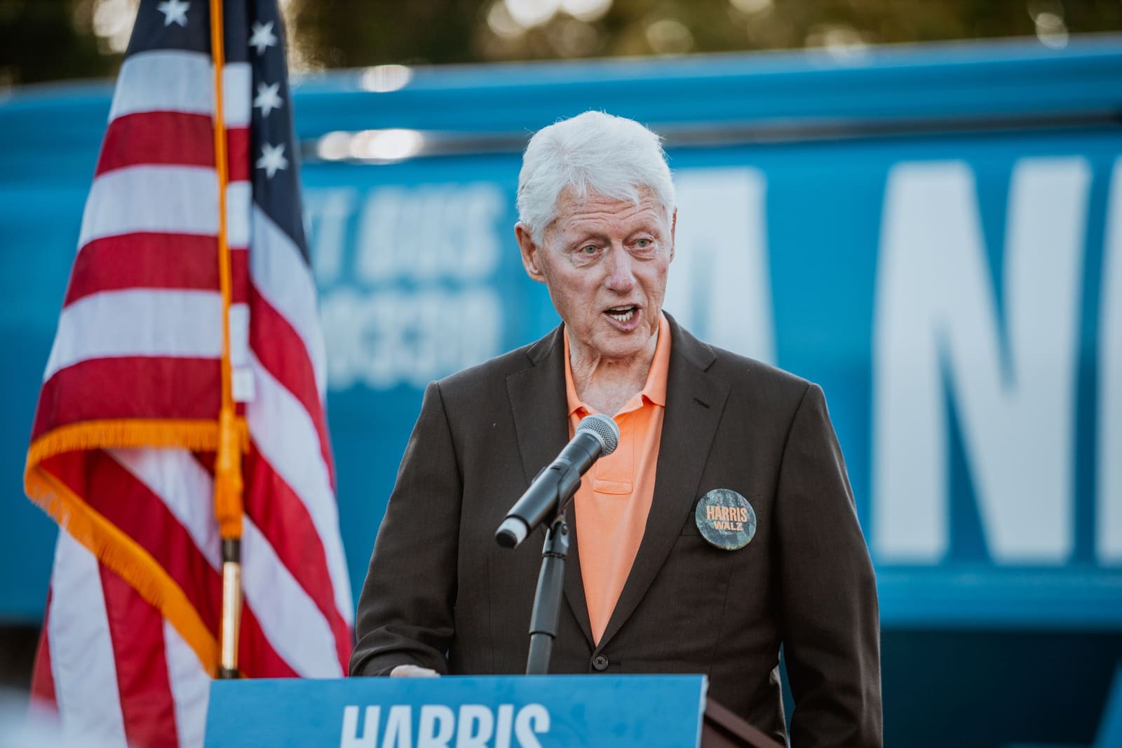 Bill Clinton at the podium beside an American flag in Greenville, NC