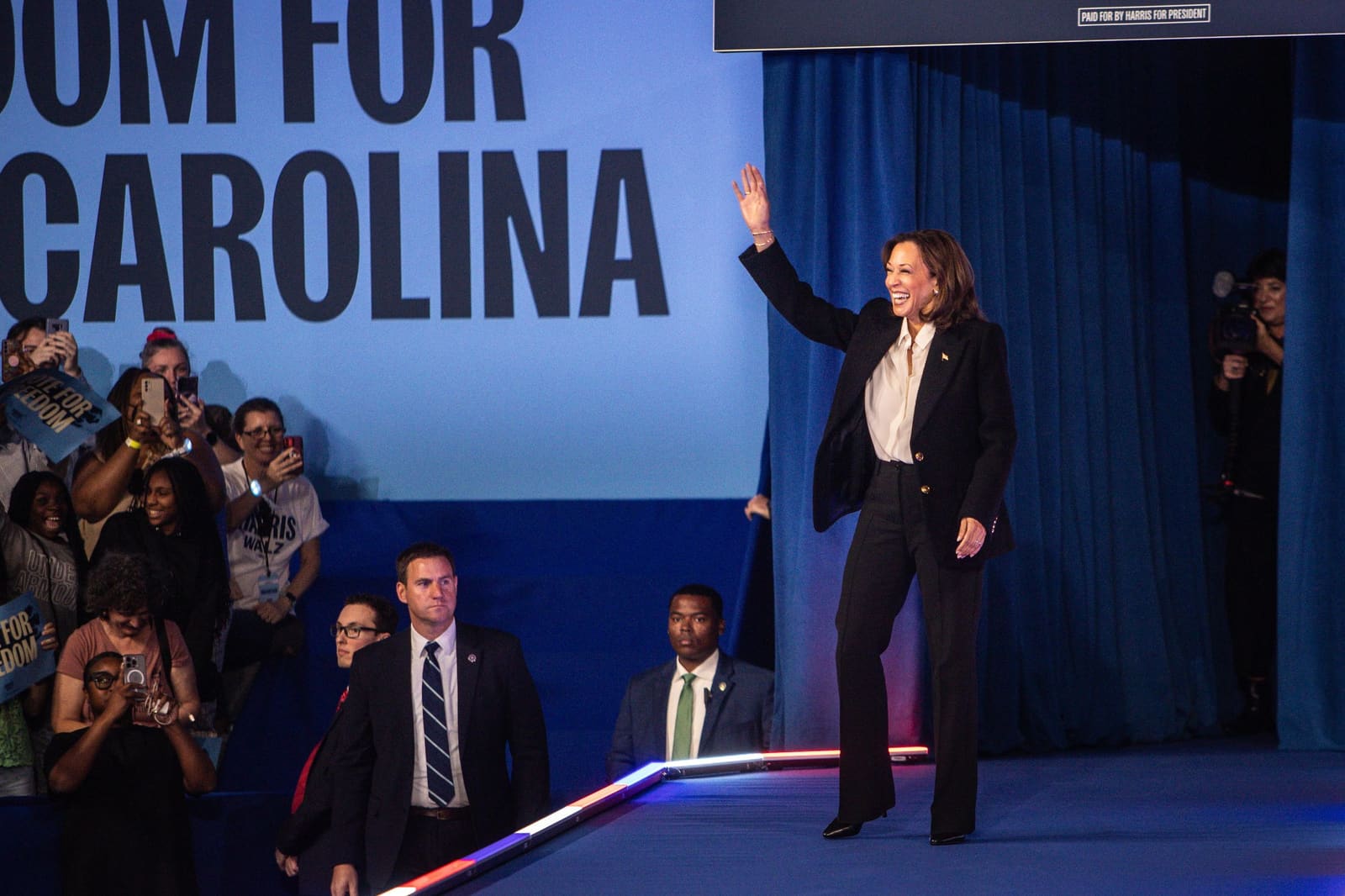 Kamala Harris waves to supporters at a Freedom for North Carolina campaign event.