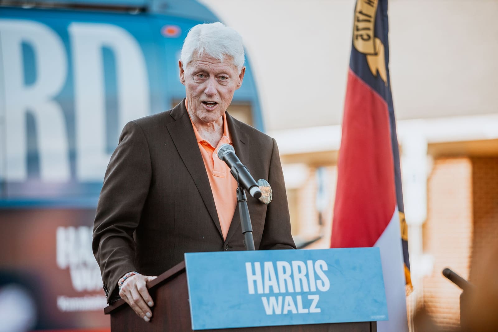 Bill Clinton at the podium with the North Carolina flag behind him