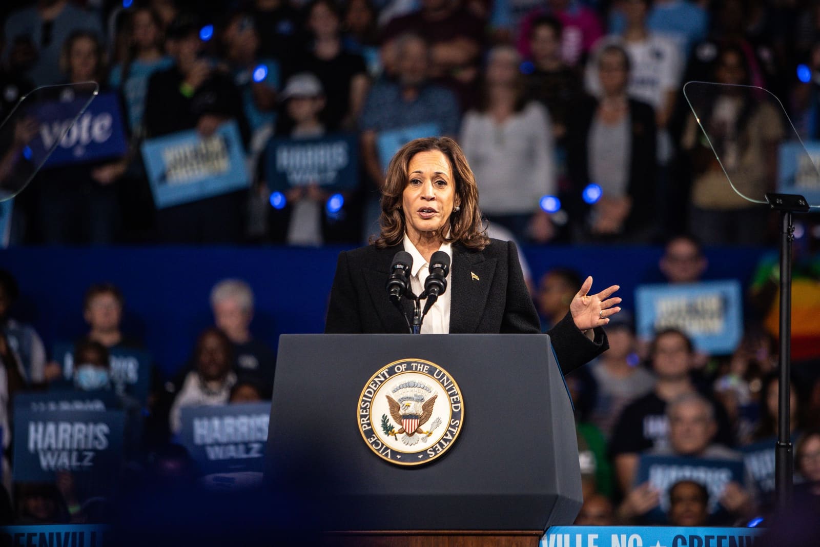 Kamala Harris speaks at the podium at Minges Coliseum, Greenville, NC