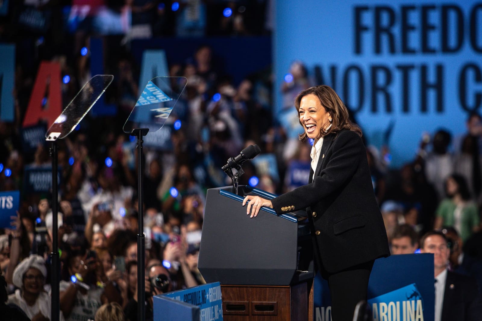 Kamala Harris smiles at the podium at Minges Coliseum, Greenville, NC