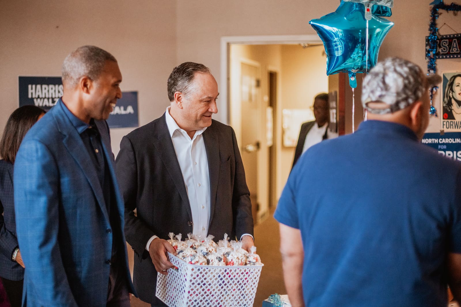 Doug Emhoff meeting people inside a campaign office
