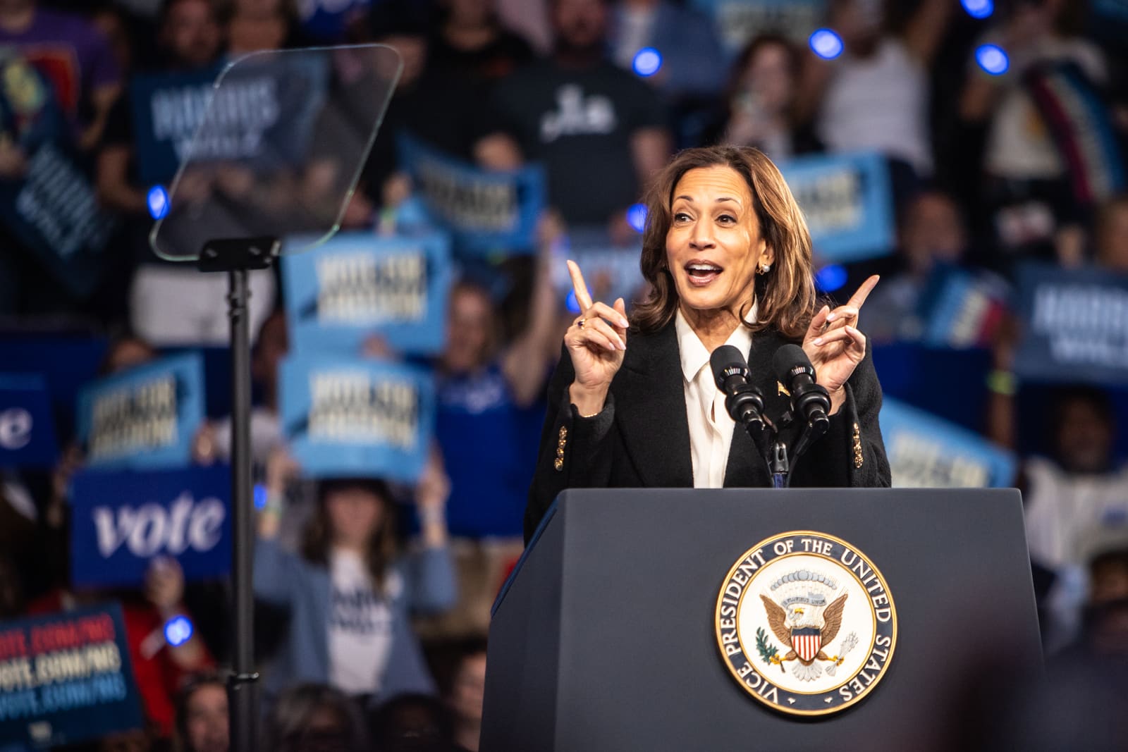 Kamala Harris points to the crowd from the podium