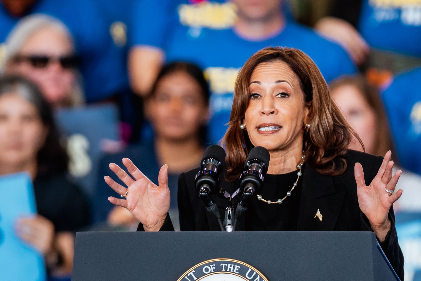 Kamala Harris with hands open, mid-sentence