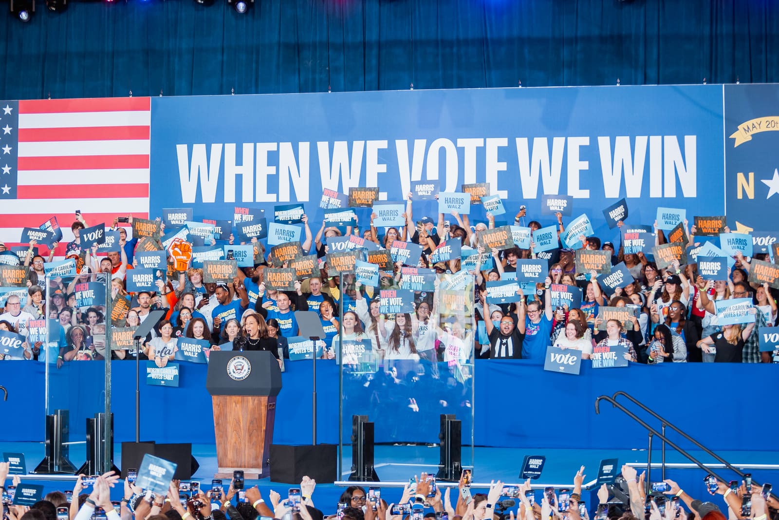 A When We Vote We Win banner over a packed crowd