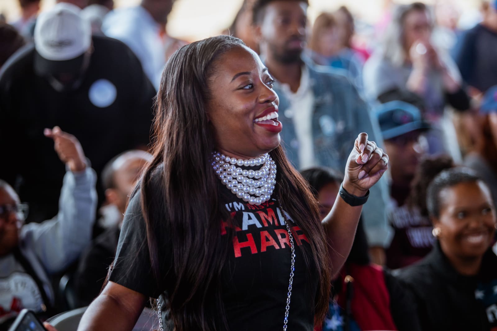 Supporter in a Kamala Harris shirt laughing in the crowd