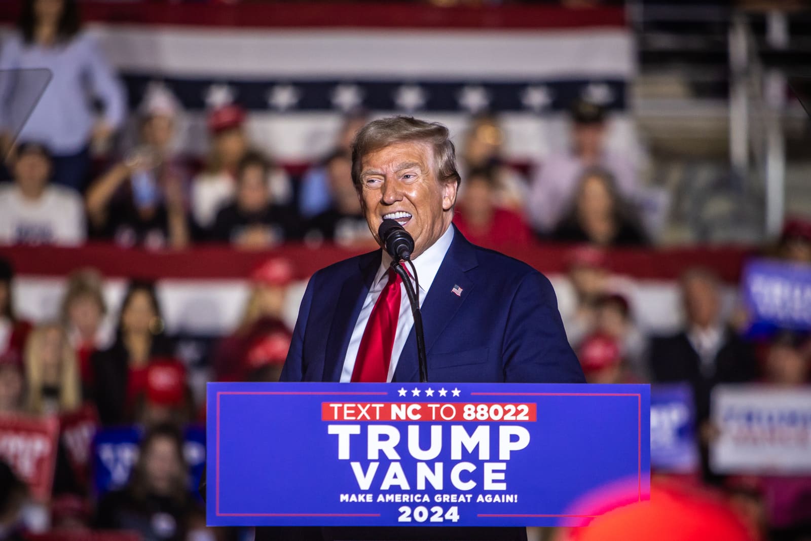 Donald Trump at the microphone at a Trump Vance lectern